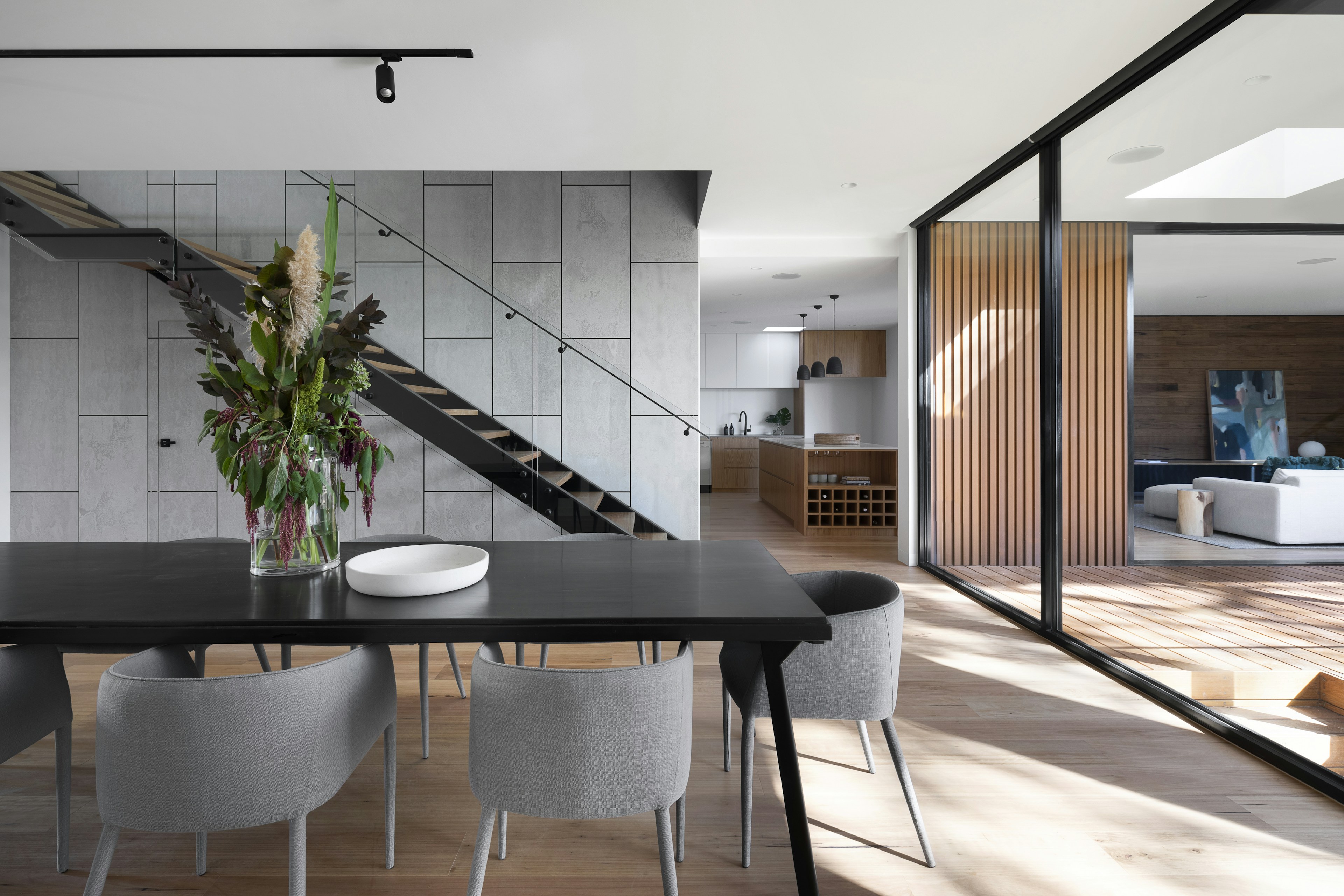Modern home interior with an open staircase and dining area