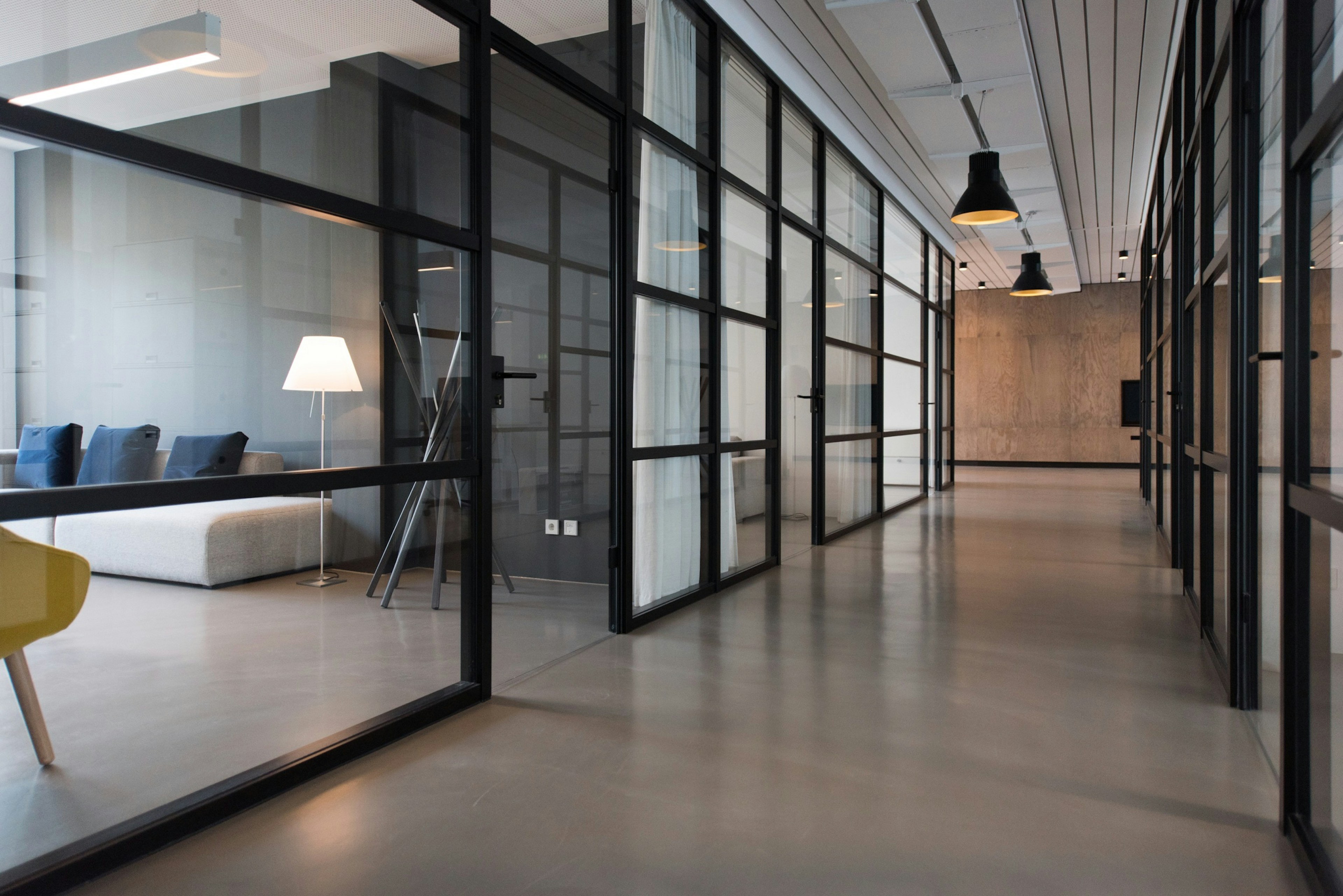 Modern office corridor with glass partitions